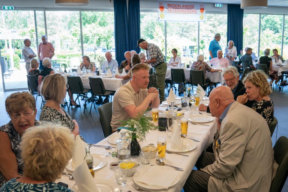 Een groep veteranen aan tafel, met elkaar aan het praten